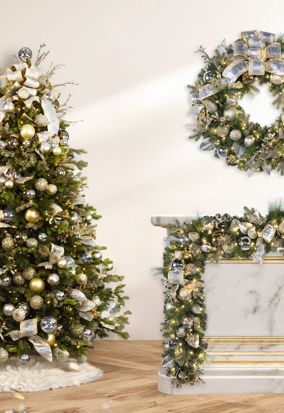 A white room with a champagne-toned tree, a wreath on the wall and garland on the mantel